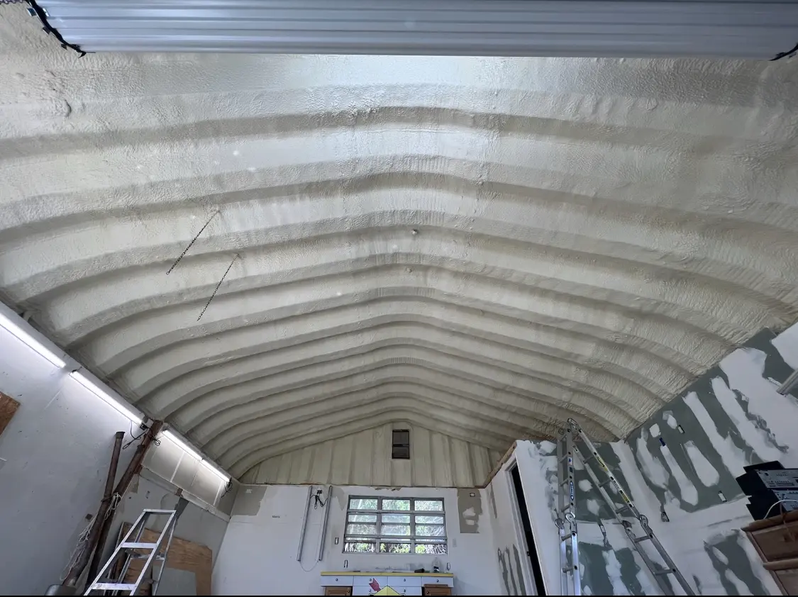 Spray polyurethane foam applied to the underside of a metal roof deck in Gladstone